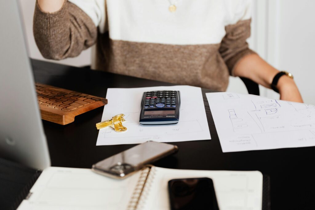 Office desk with paperwork and computer, symbolizing managing accounts receivable and business cash flow.